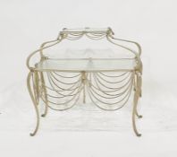 A two-tier lozenge-shaped glass-topped and iron-framed table with iron swag decoration Condition