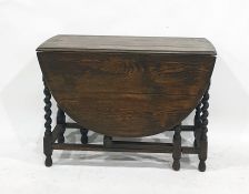 A 20th century oak drop-leaf dining table on barleytwist supports, stretchered base