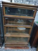 Oak four-section Globe Wernicke bookcase, the four sections bearing ivorine labels marked 'The