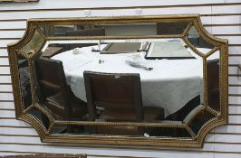 Multi-plate wall mirror, rectangular in form with concave corners, in egg and dart moulded frame