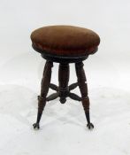 A Victorian adjustable circular piano stool, the padded seat on extending column, ribbed and