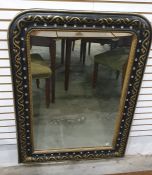 Mirror in ebonised frame with gilt ribbon and vine decoration