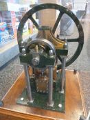 Model steam engine mounted on mahogany base and housed under perspex