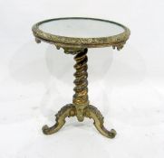 A 19th century mirror-top circular centre table, the moulded edge above a gilt twisted tapering