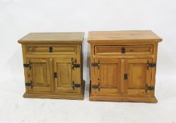 Pair of pine bedside chests, the rectangular tops above single drawers, two cupboard doors, plinth