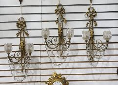 Three gilt metal and glass double-branch wall light brackets with ribbon and foliate decoration,