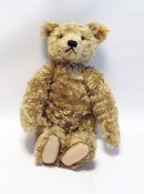 A Steiff plush bear with growler and a linen sailor jacket glass eyes and a stitched nose and