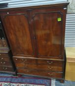 A 19th century mahogany linenpress, the moulded pediment above two cupboard doors enclosing linen