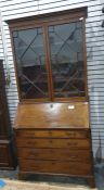 A 19th century mahogany bureau bookcase with ogee moulded pediment above astragal glazed doors,