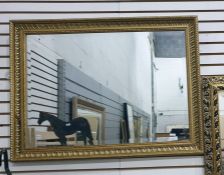 Gilt rectangular wall mirror together with another mirror.