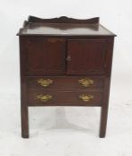 A 19th century mahogany commode with three-quarter galleried top above two cupboard doors, converted