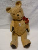 A large plush bear, stitched nose and mouth, glass eyes some repairs 81cm approximately