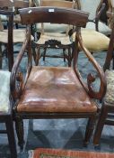 19th century mahogany carver chair with scrolled arms, turned and reeded supports, peg feet and a