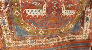 Turkish silk rug, the central field red ground with deer decoration, on a stepped border, in reds, c