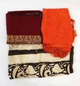 Batik printed fabric, paisley pattern dark brown on cream ground, an orange silk embroidered shawl