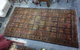 Eastern rug with central field divided into fifty five squares each sporting different motifs on a