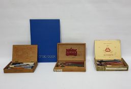 Box of artist's materials to include brushes, paper, a guillotine, two black painted tin boxes,