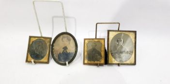 Three 19th century gilt metal photograph frames enclosing photographic portraits and an oval metal