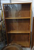 Twentieth century teak display cabinet, three banks of sliding glass doors, enclosing shelves, the
