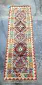 Eastern runner with five central medallians on a cream ground in purples, reds, greens and orange