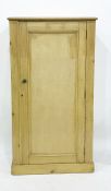 A pine single door cabinet, moulded top, above a single panelled door enclosing shelves, the whole