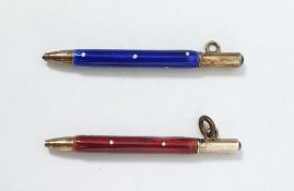 Two gold-coloured metal and enamel miniature bridge/pendant pencils, one with blue and white spotted