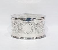 Electroplated biscuit tin of oval form, scrolling foliate engraving