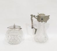 Silver plated cut glass claret jug with lion mask spout, the body cut with flowerheads and a