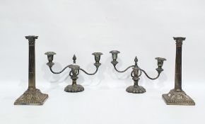 Two pairs of silver plated candlesticks, the first pair with three lights issuing from two