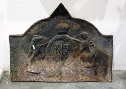 A cast iron armorial fireback of arched rectangular section, cast with the Royal Arms within a