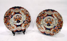Pair of Imari chargers, each painted with a central cartouche and jardiniere of flowers, the borders