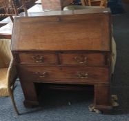19th century oak bureau of two short over one long drawer, the recessed base raised upon bracket