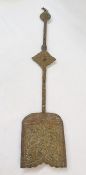 An Asian brass and copper spade form staff, mounted with cinnebar lacquer and turquoise, of spade
