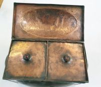 An Arts and Crafts copper hinged rectangular section tea caddy and cover and two liners, with oval