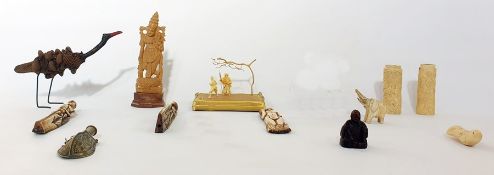 A collection of Asian sculptures, to include two Japanese carved ivory handles carved with