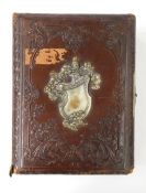 Victorian photograph album containing portraits and group shots and another metal bound embossed