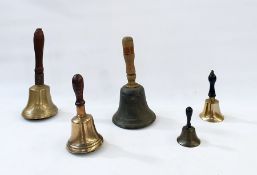 Five brass and metal hand bells, with turned wooden handles, one incised 