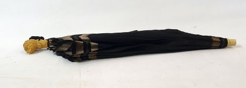 Black and silver  fabric parasol with a bakelite handle in the form of a dogs head