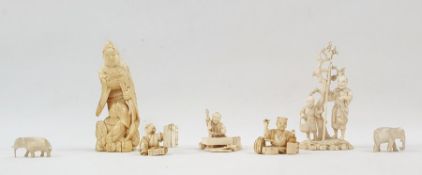 Chinese carved ivory okimono in the form of man with turtle, boy seated at his feet, 10cm high; a
