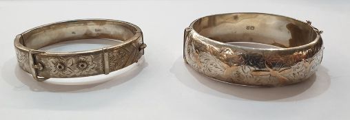 Silver bangle of belt and buckle design with scroll engraving and another silver gold applied