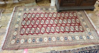20th century Persian rug, the red ground central field with three rows of 13 elephant foot cream