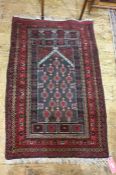Persian prayer rug, the black ground central field with repeating pattern, on a stepped border,