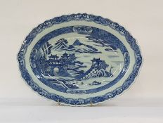 Chinese porcelain shallow dish, oval with everted rim, pagodas in lakeside landscape painted in