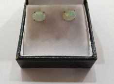 Pair of white metal Ethiopian opal stud earrings, each with oval cabochon stone