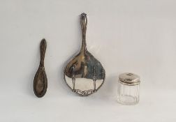 Silver-backed dressing table mirror, a silver-backed dressing table brush and a silver-lidded