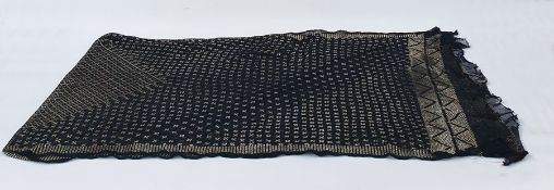 Early 20th century black Assuit shawl on a black mesh ground with hammered gold-coloured