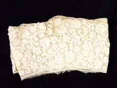Early handmade tape-lace backed onto muslin, featuring floral decoration, possibly cut from a