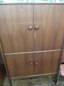 A. Younger Limited, mid 20th century teak cabinet, top section with two glass shelves, shelving to