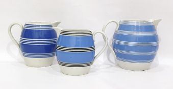 Three variously sized blue-banded jugs, ovoid (3)