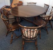 Dark Ercol drop-leaf dining table and eight chairs